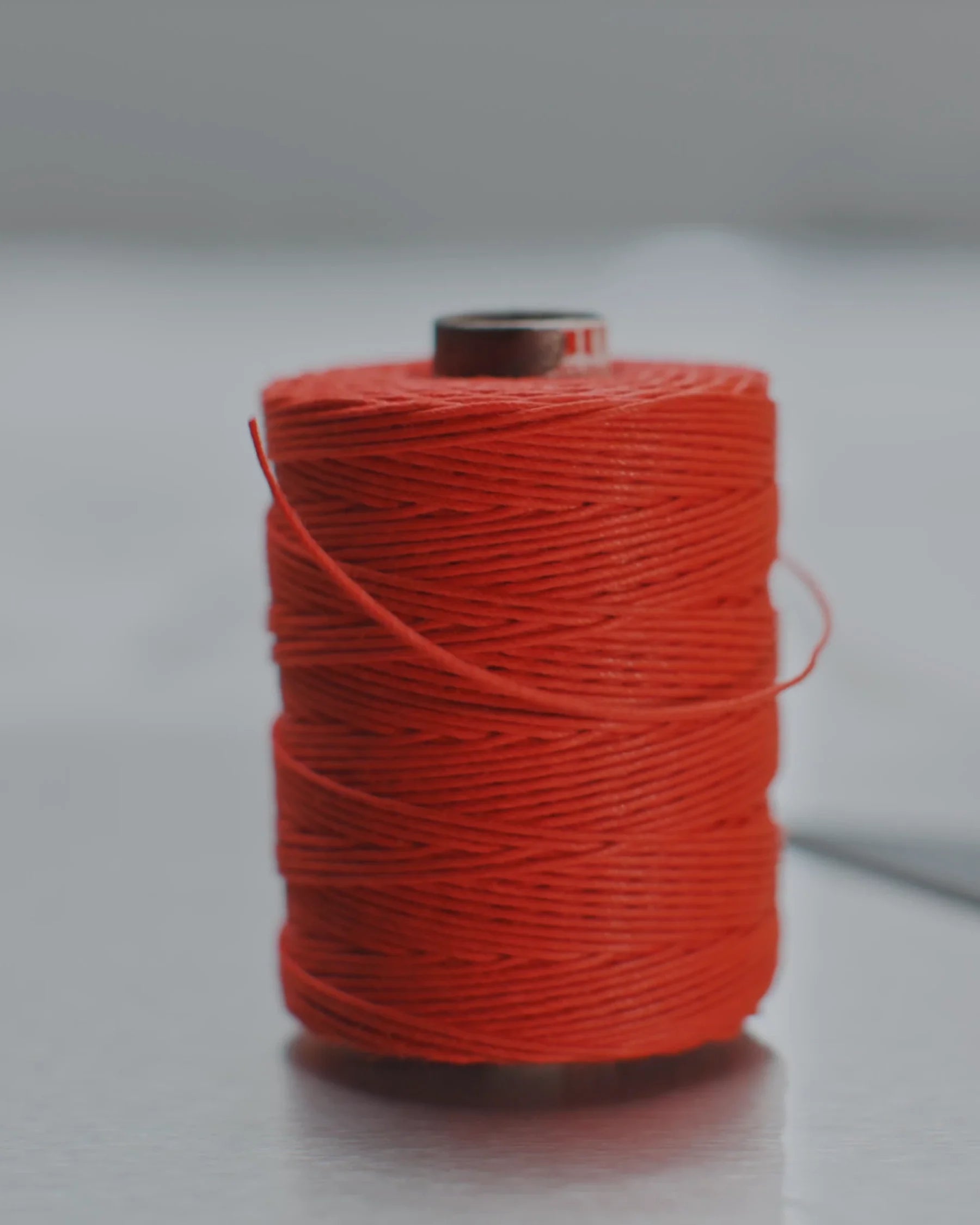 Carrete de hilo rojo sobre la mesa de corte